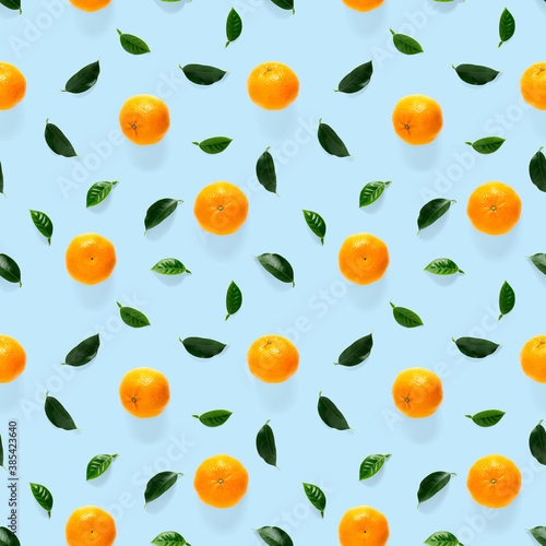 Fototapeta Naklejka Na Ścianę i Meble -  Mandarine seamless pattern, tangerine, clementine isolated on blue background with green leaves. Collection of fine seamless patterns.