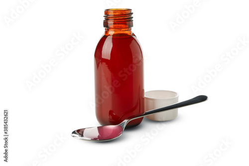 Medicine bottle and spoon with syrup isolated on white background