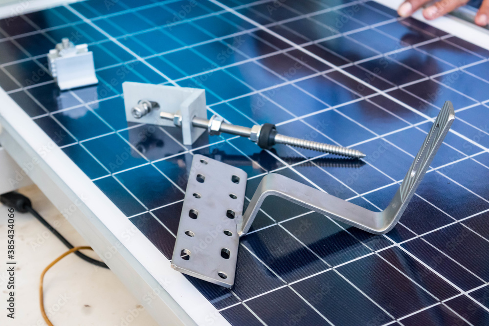Fototapeta premium The technician's hand was holding the solar cell equipment to install the solar panel.