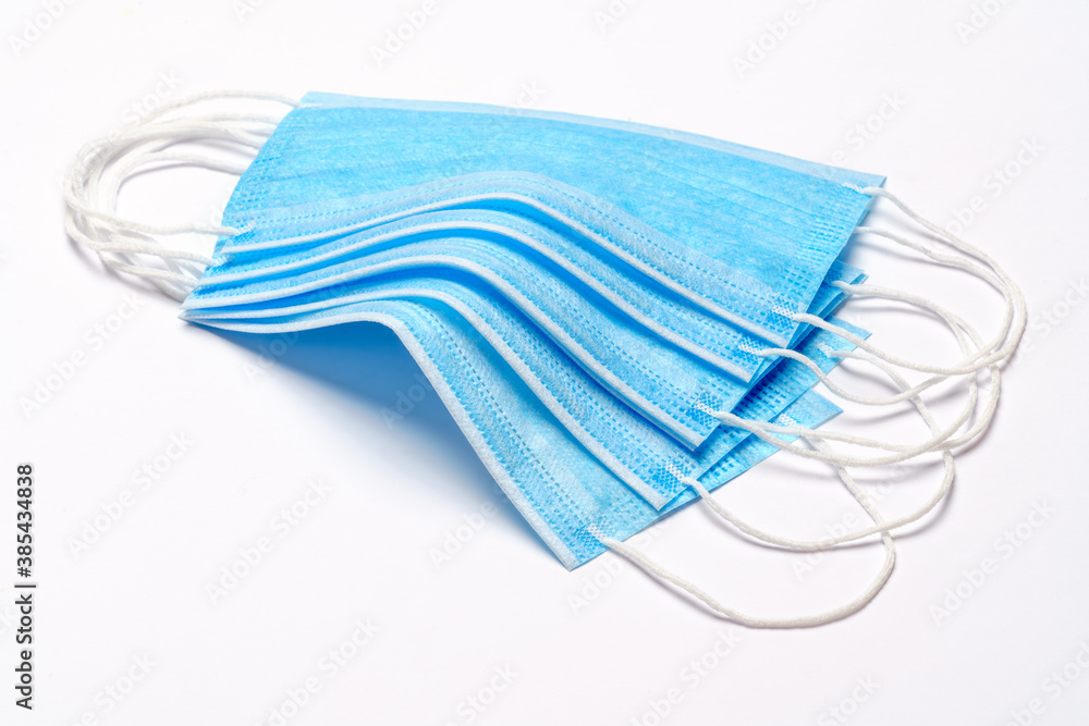 coronavirus COVID-19 pandemic concept - stack of antiviral surgical protective medical mask for protection against corona virus coronavirus COVID-19 pandemic concept - stack of antiviral surgical protective medical mask for protection against corona virus