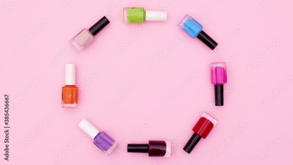 Colorful bottles of nail polishes move in circle . Stop motion Colorful bottles of nail polishes move in circle . Stop motion