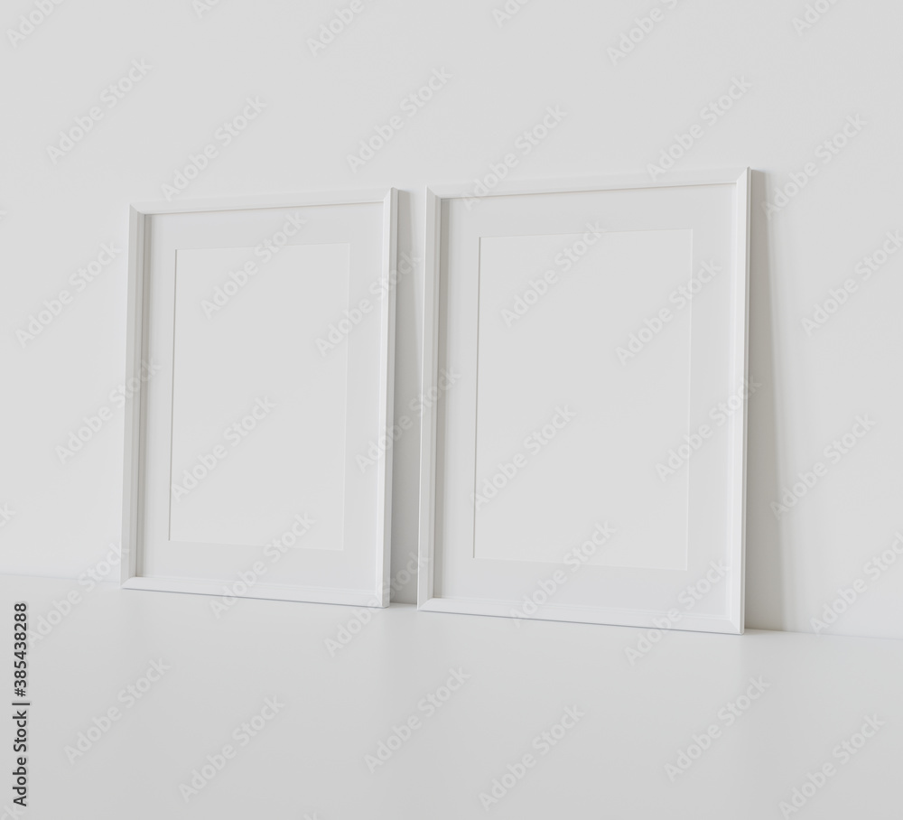 Two white frames leaning on white floor in interior mockup. Template of pictures framed on a wall 3D rendering Two white frames leaning on white floor in interior mockup. Template of pictures framed on a wall 3D rendering
