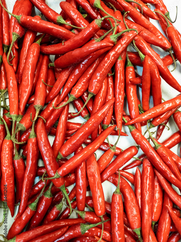 Chili peppers are arranged for background design. Piles of kitchen spices to create designs about agriculture, food, nature, & healthy living. Chili peppers are arranged for background design. Piles of kitchen spices to create designs about agriculture, food, nature, & healthy living.