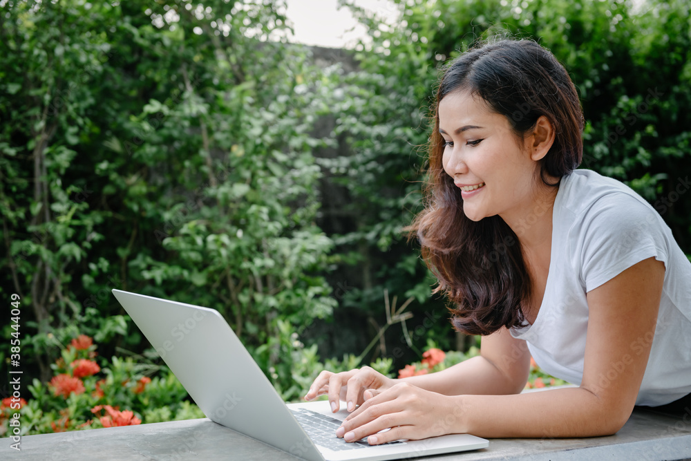 Beautiful Woman Relaxing and Using Laptop While Laying on Garden Bench, Asian Woman Working Online on Laptop Device and Joying .Social Media. Relaxation Leisure Activities Lifestyles/Work at Home Beautiful Woman Relaxing and Using Laptop While Laying on Garden Bench, Asian Woman Working Online on Laptop Device and Joying .Social Media. Relaxation Leisure Activities Lifestyles/Work at Home