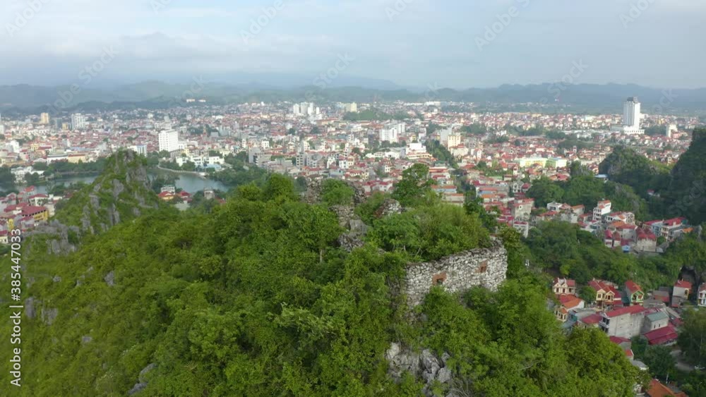 Aerial landscape: Ancient wall of The Mac dynasty as known as Northern Mac or House of Mac, old ruins located on a mountain with panoramic city Lang Son backwards, Vietnam. Aerial landscape: Ancient wall of The Mac dynasty as known as Northern Mac or House of Mac, old ruins located on a mountain with panoramic city Lang Son backwards, Vietnam.