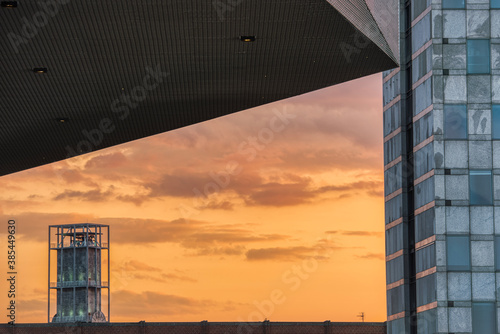 Aarhus skyline at dusk: the Radhus (city hall) watches over the city at sunset. Modern buildings in the DOKK1 plaza at sundown convey industrial and contemporary architectural style - Arhus, Denmark