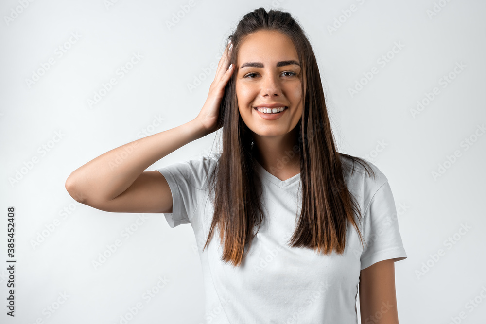 Positive Young brunette woman laughing. Studio shot white background. Human emotions facial expression concept Positive Young brunette woman laughing. Studio shot white background. Human emotions facial expression concept