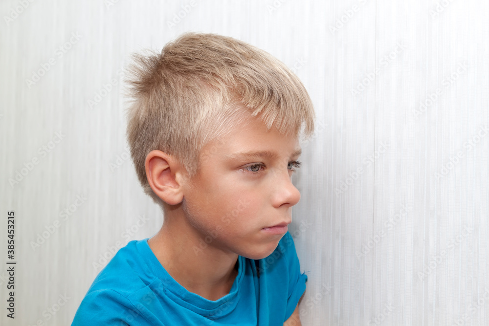 Portrait of pensive dreamy boy to something he imagines in mind, looking to side while deep in thought Portrait of pensive dreamy boy to something he imagines in mind, looking to side while deep in thought