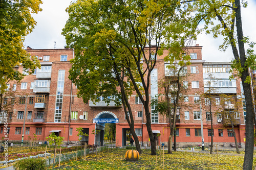In the courtyard of stalinka building. Orange and green trees, Ukraine, Kharkov