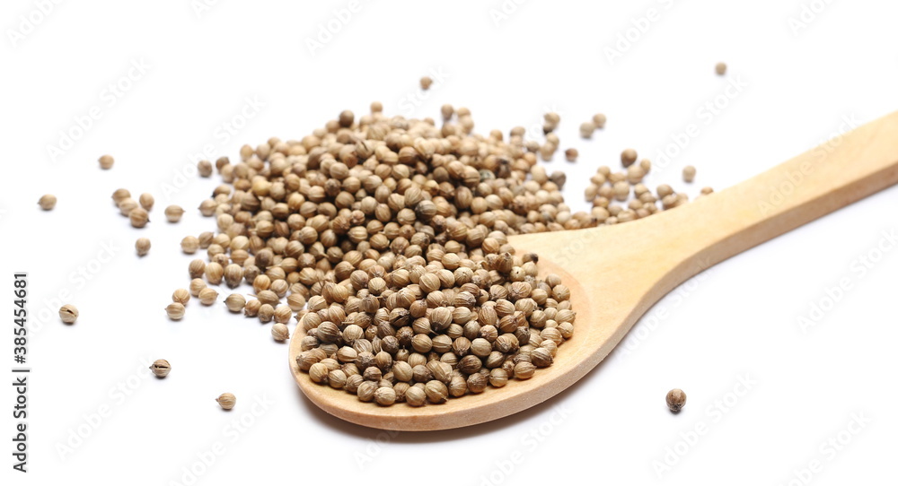 Coriander seeds pile with wooden spoon isolated on white background Coriander seeds pile with wooden spoon isolated on white background