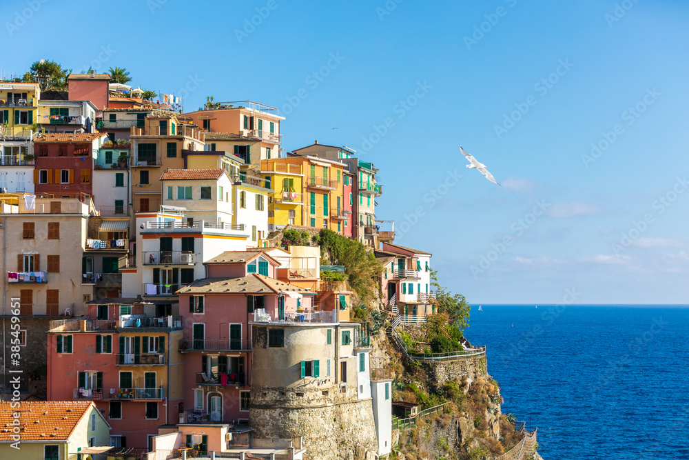 Manarola, Cinque Terre in Liguria in Italy. Aerial view of colorful houses and the blue sea in the background. Coastline landscape.