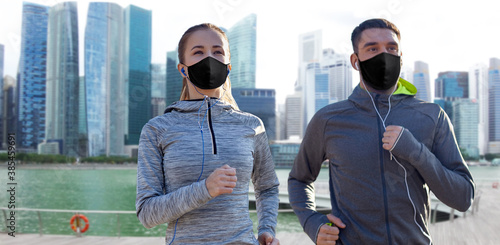 Canvas Print fitness, sport and health concept - couple wearing face protective black masks f