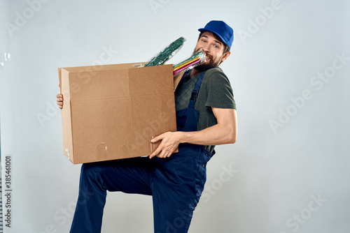 Man in working uniform with boxes in hands delivery loading lifestyle © SHOTPRIME STUDIO