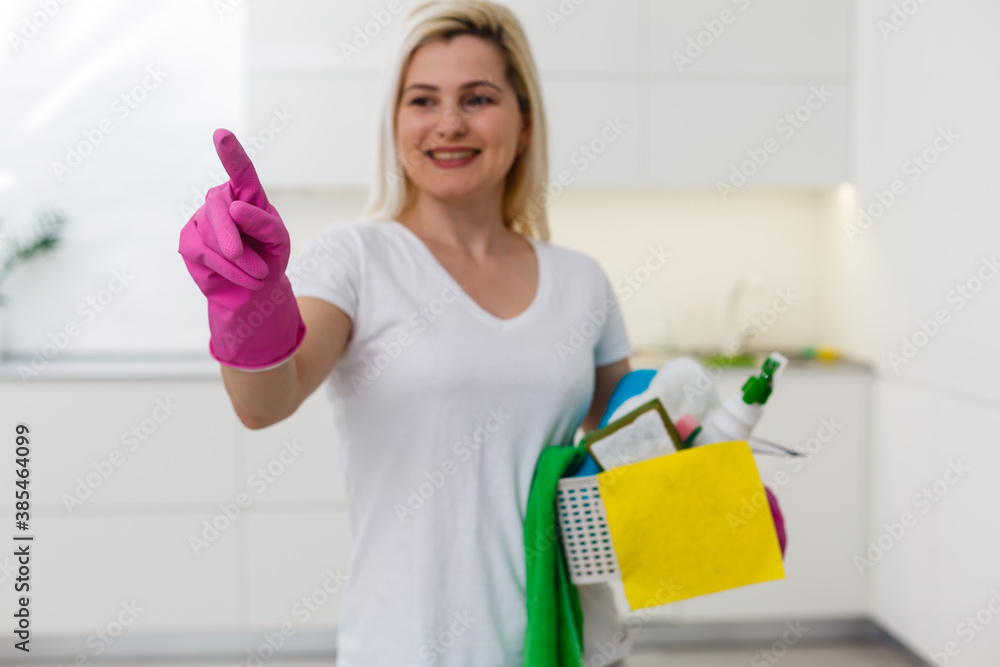 Portrait of smiling modern woman with long hair at modern home showing smart home app Portrait of smiling modern woman with long hair at modern home showing smart home app