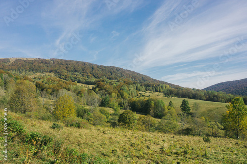 Bieszczady National Park in Poland landscape. Autumn mountain trekking. Rural scenery background. Hiking trail on the hill. Blue sky idyllic view.