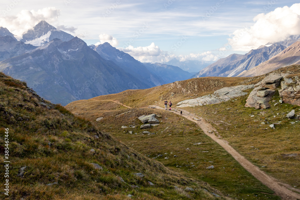 Walking path in the Valais Alps of Switzerland on a summer evening. 