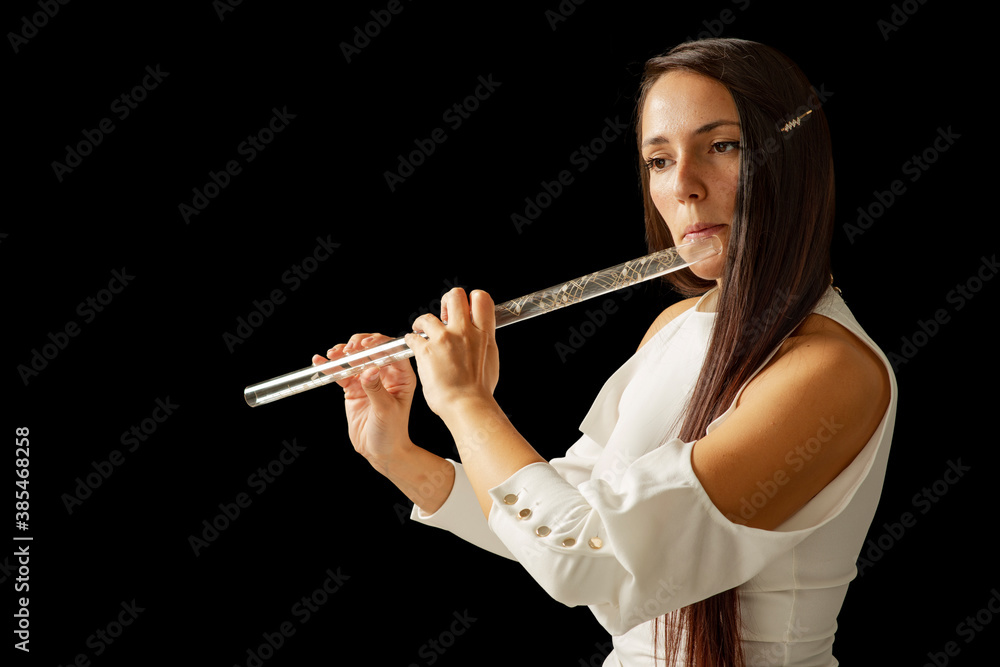 Fototapeta premium A young girl plays a crystal flute