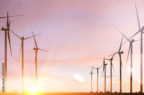 Wind turbines and renewable energy source in beautiful sunset.