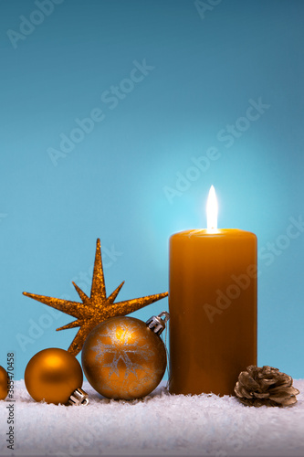 Christmas card with decoration and yellow advent candle .