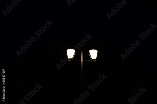 Street lamp in the night. The bright light of a lamp. Abstract style.