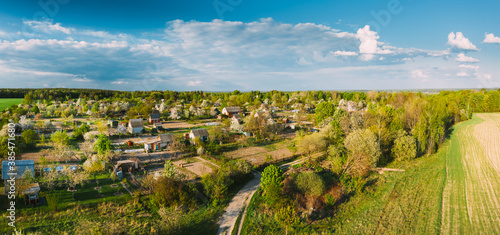 Countryside Rural Landscape With Small Village, Gardens And Green Field In Spring Summer Day. Elevated View. Panorama © Grigory Bruev