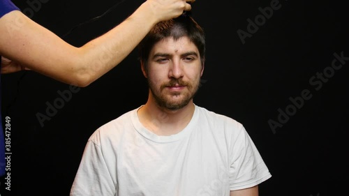 Man get a buzz cut from hair dresser.