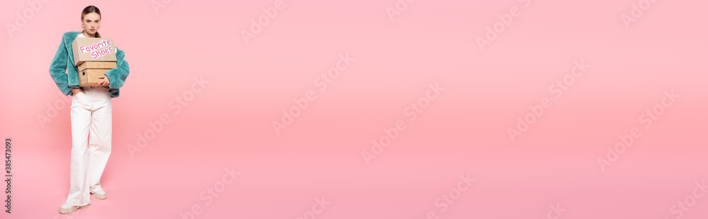 horizontal concept of stylish woman in sunglasses holding boxes with favorite shoes lettering on pink, black friday concept horizontal concept of stylish woman in sunglasses holding boxes with favorite shoes lettering on pink, black friday concept