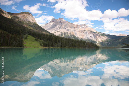 View of Bow lake with mountains reflected in still lake during summer in Banff National Park, Canadian Rockies, Alberta, Canada.