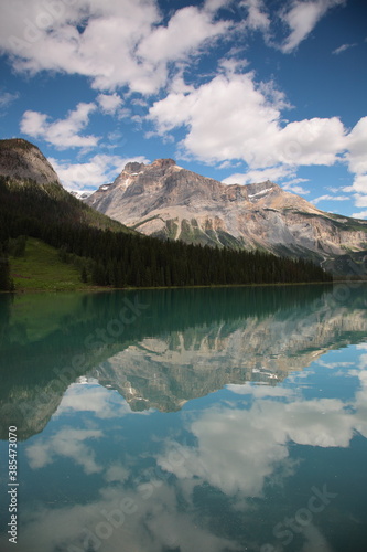 View of Bow lake with mountains reflected in still lake during summer in Banff National Park, Canadian Rockies, Alberta, Canada.