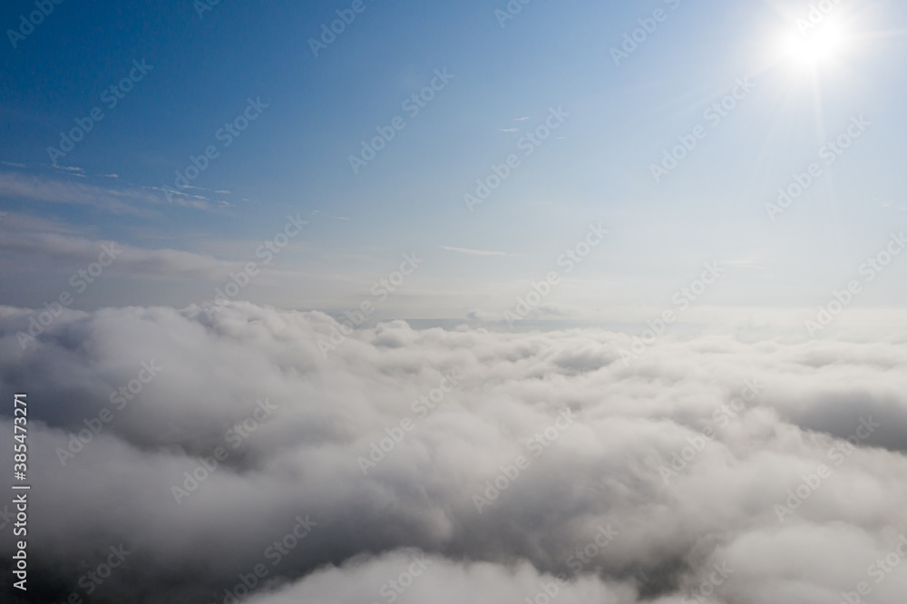 Aerial view over the sky clouds in day time with solar halo on the clouds Aerial view over the sky clouds in day time with solar halo on the clouds