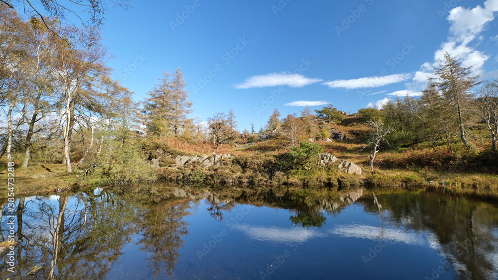 Autumn colours reflected in a Lake District tarn above derelict slate quarries at Hodge Close Autumn colours reflected in a Lake District tarn above derelict slate quarries at Hodge Close
