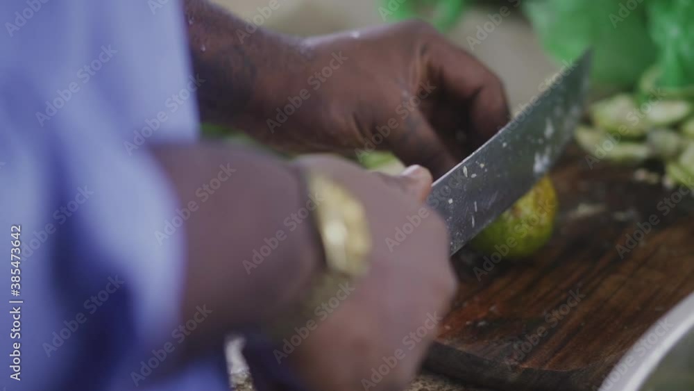african man cutting limes with a knife african man cutting limes with a knife