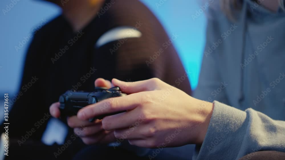 Close-up of hands of a girl gaming with her boyfriend Close-up of hands of a girl gaming with her boyfriend