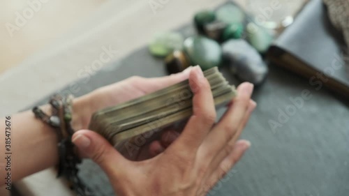 young girl shuffles Tarot cards