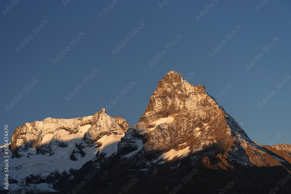 top of Mount Belalakaya in Dombai at sunrise with blue sky.