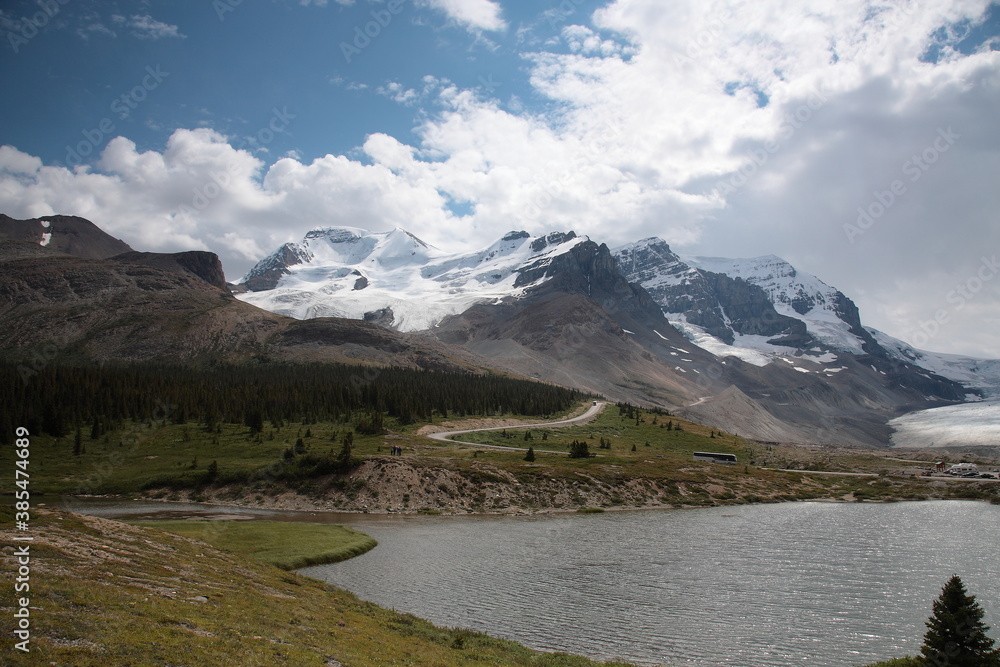 View of Athabasca Glacier with snow covered mountain peaks during summer in the boundary of Banff and Jasper National Park, Canadian Rockies, Alberta, Canada.