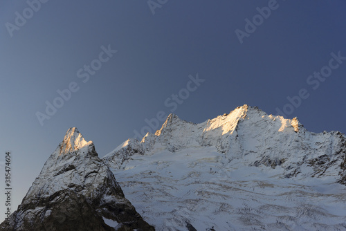 mountain top with a ridge in Dombai at sunrise with blue sky.