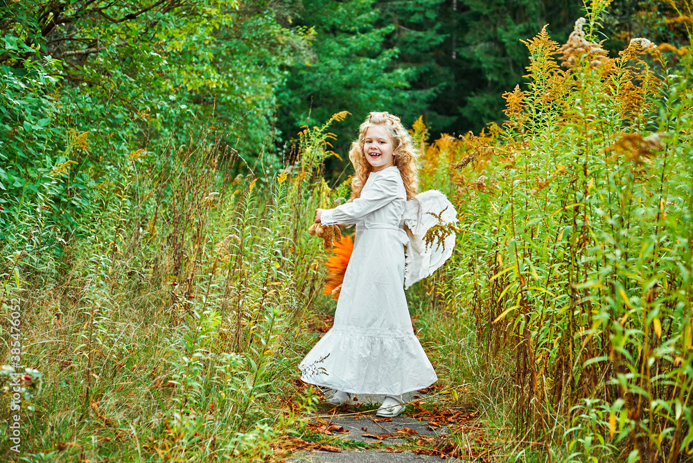 portrait of a little girl in a white dress. angel with wings portrait of a little girl in a white dress. angel with wings