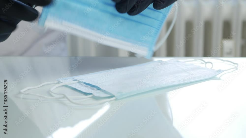 Doctor Wearing Black Gloves Check the Protective Face Masks Quality Doctor Wearing Black Gloves Check the Protective Face Masks Quality