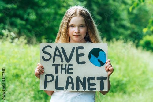 caucasian blonde girl activist with save the planet poster in park. preteen kid volunteer against pollution, global warming, recycle garbage. Ecology environmental problem. Zero waste