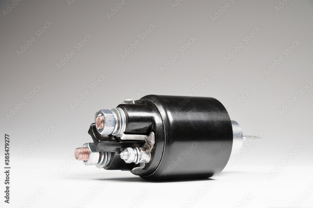 Solenoid for Starter for a car on gray background. Car spare parts. Spare parts for the starter Solenoid for Starter for a car on gray background. Car spare parts. Spare parts for the starter