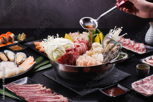 Shabu Shabu or Sukiyaki, a popular dish of pork, beef, shrimp, squid, seafood and fresh vegetables. Placed on a table with a boiling pot boiling.
