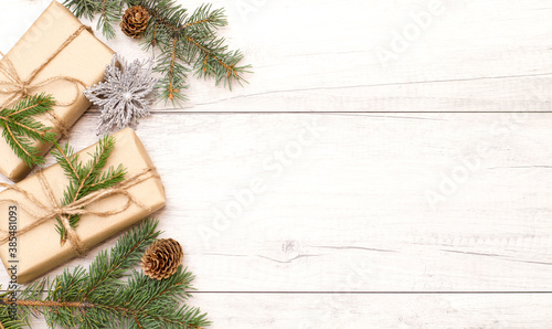Christmas background, frame and wallpaper. Happy New Year composition. Christmas gift, pine cones, fir branches on wooden white flat