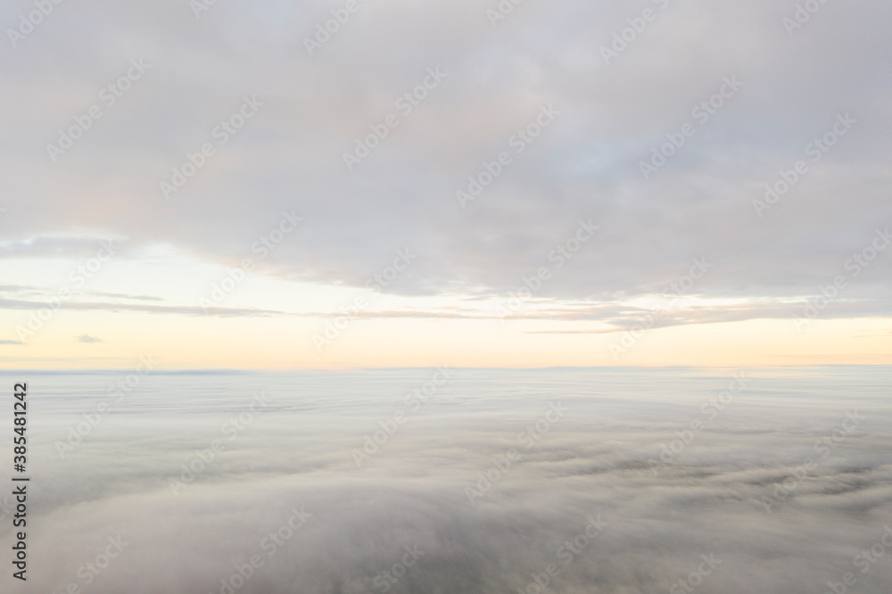 Aerial view white clouds. View from drone. Aerial top view cloudscape texture. Texture of clouds. View from above. Panorama clouds background