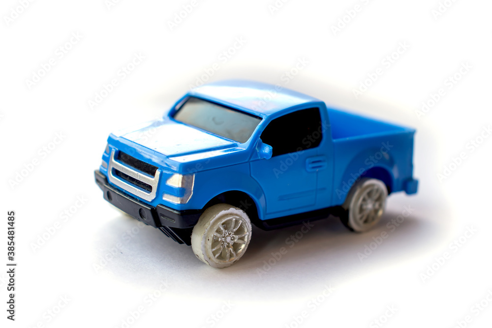 Children’s toy little blue car on a white background.