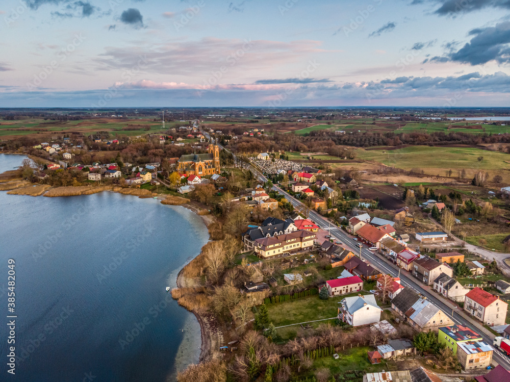 Aerial view of Rajgrodzkie Lake and church in Rajgrod, autumn time, Poland
