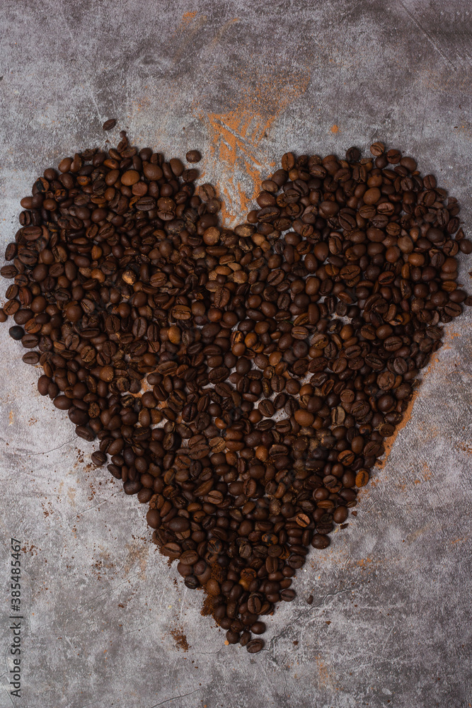 heart made of coffee beans on a gray background. heart made of coffee beans on a gray background.