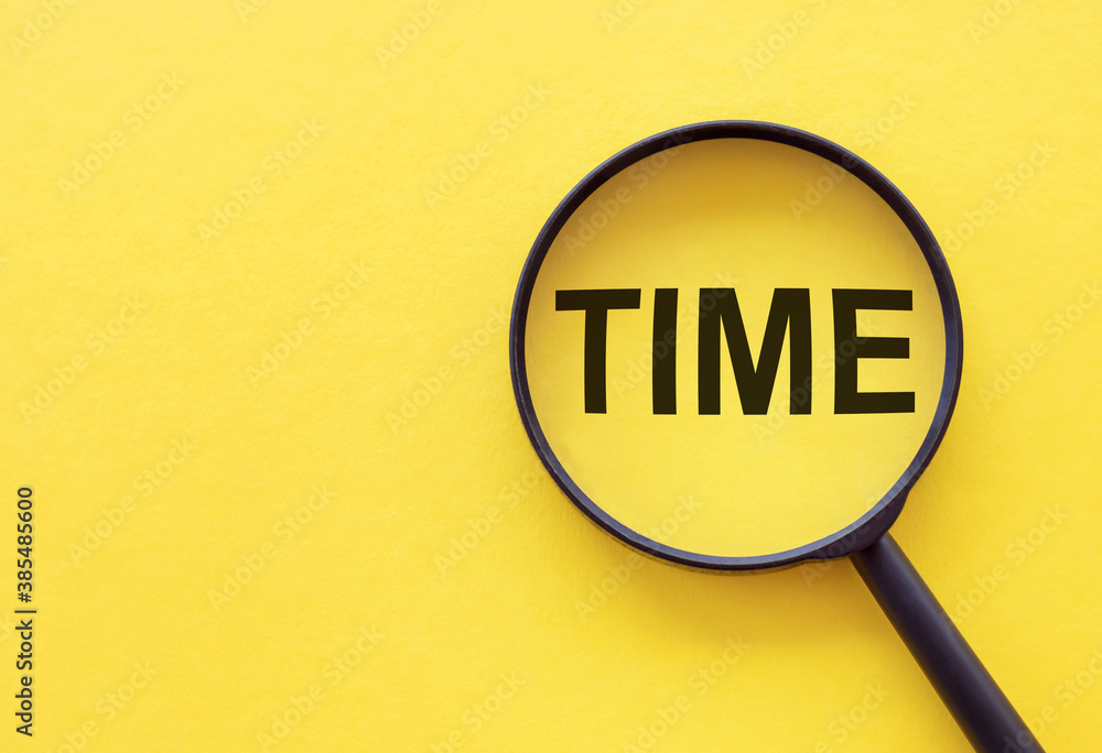 Time Word written on magnifier glass. Search time concept. Time Word written on magnifier glass. Search time concept.