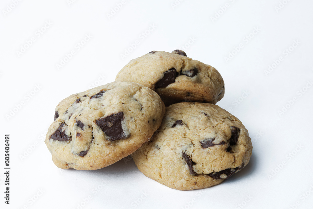 three fresh homemade American cookies with chocolate chips isolated on white background