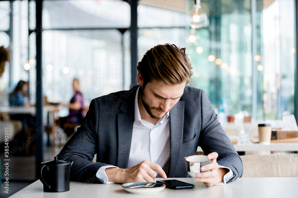 Pensive businessman working in cafe with mobile phone. Pensive businessman working in cafe with mobile phone.